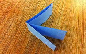 A strip of paper folded into quarters.